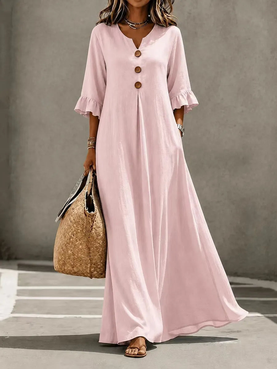 Vestido comprido para menina com decote em V, fecho frontal de botões, mangas com folhos e bolsos.