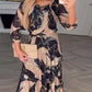 Vestido elegante em chiffon com estampado e mangas a três quartos