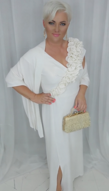O vestido apresenta um decote em V adornado com folhos em estampado floral