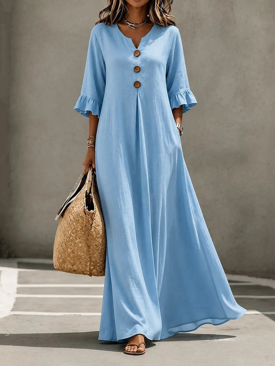 Vestido comprido para menina com decote em V, fecho frontal de botões, mangas com folhos e bolsos.
