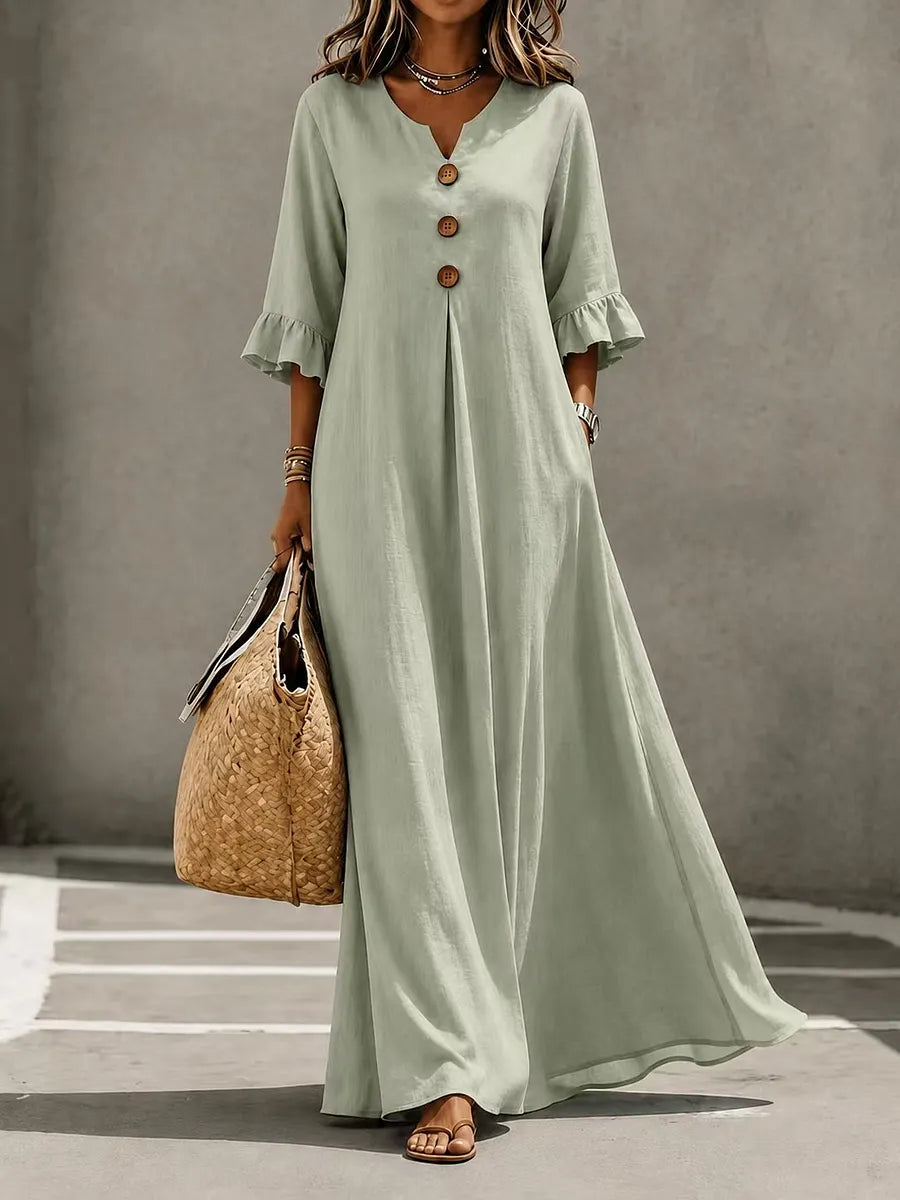 Vestido comprido para menina com decote em V, fecho frontal de botões, mangas com folhos e bolsos.