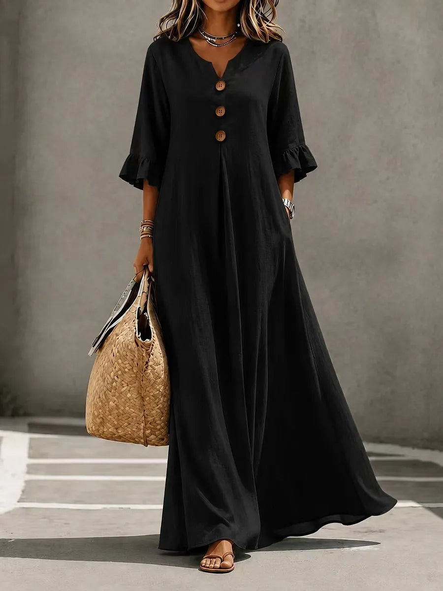 Vestido comprido para menina com decote em V, fecho frontal de botões, mangas com folhos e bolsos.