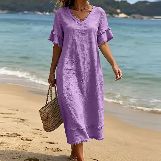 Vestido de mulher em algodão com decote em V, corte largo e borlas.