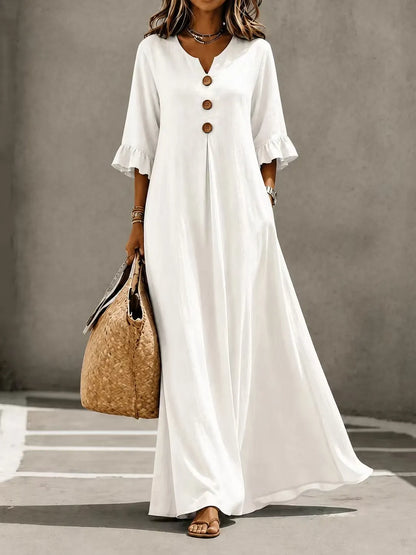 Vestido comprido para menina com decote em V, fecho frontal de botões, mangas com folhos e bolsos.