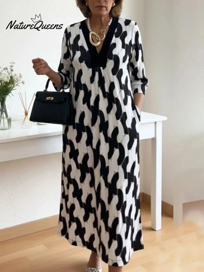 Um elegante vestido midi adornado com estampados artísticos e decote em V