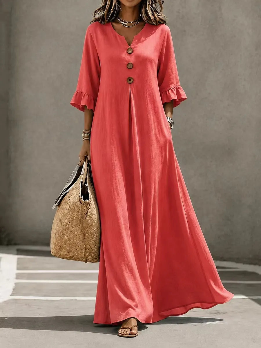 Vestido comprido para menina com decote em V, fecho frontal de botões, mangas com folhos e bolsos.