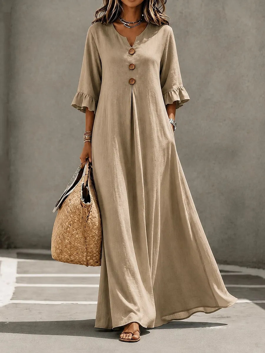 Vestido comprido para menina com decote em V, fecho frontal de botões, mangas com folhos e bolsos.
