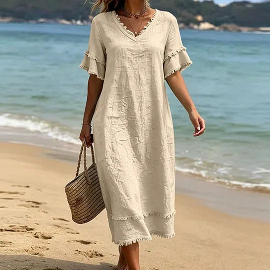 Vestido de mulher em algodão com decote em V, corte largo e borlas.