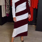 Vestido feminino elegante e às riscas com ombros largos